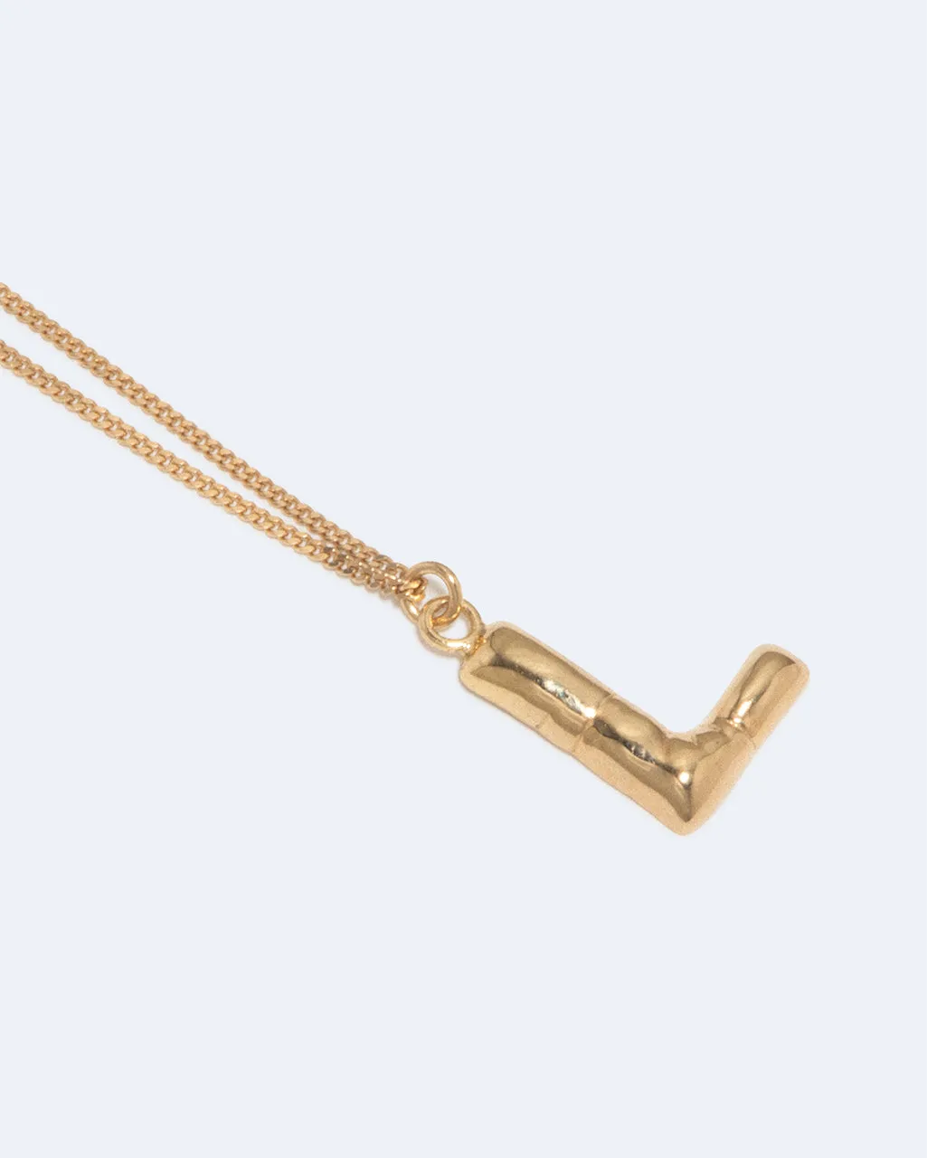 Completedworks Classicworks L collier plaqué or initiale dorée
