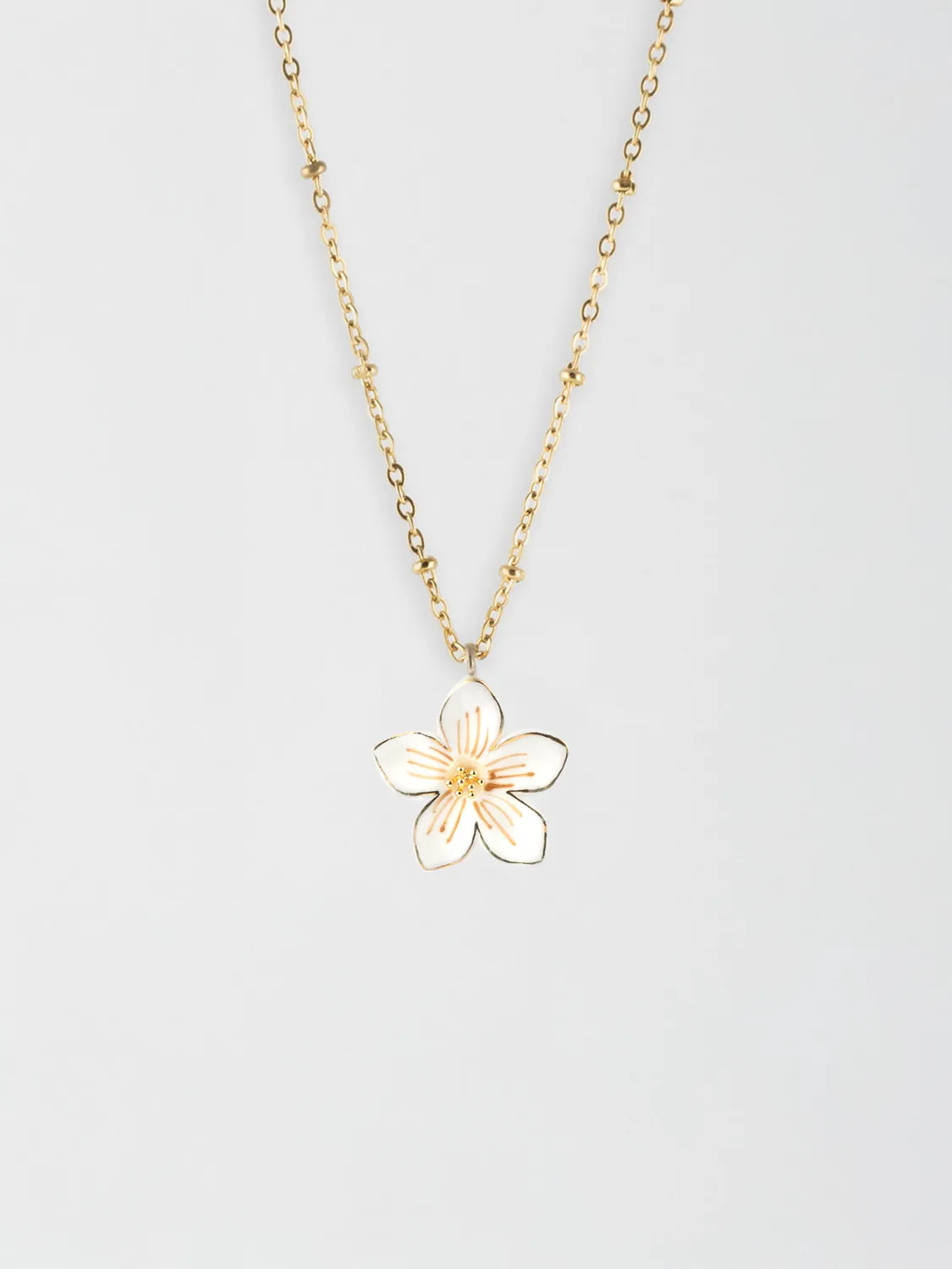 Nach Bijoux Collier fleur blanche porcelaine dorée
